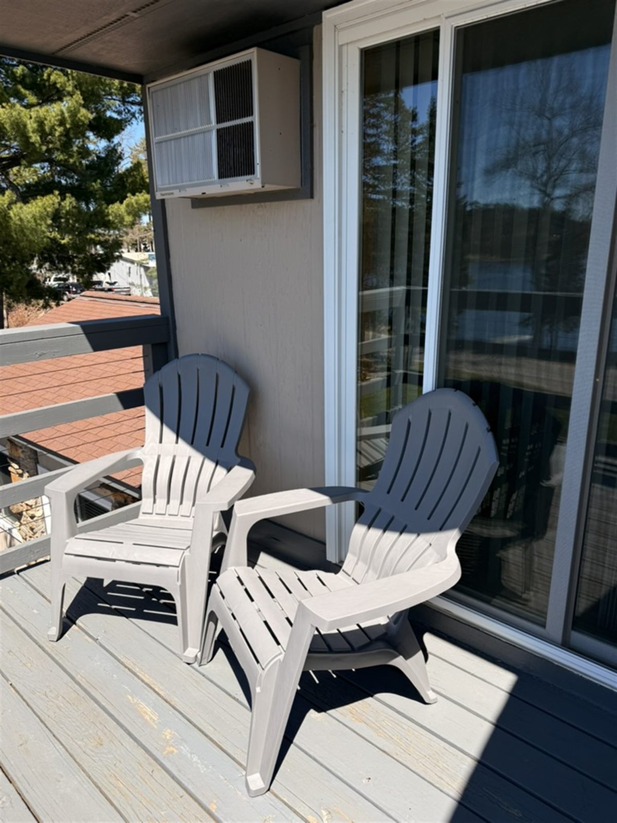 Two deck chairs in the sun above the water